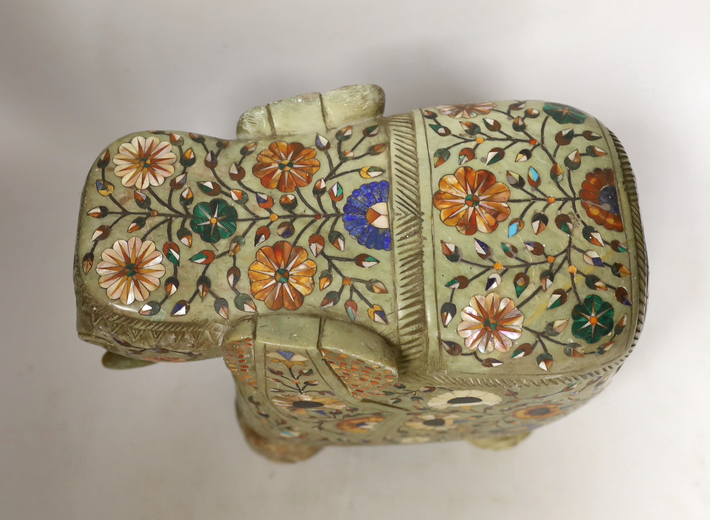 An Indian carved soapstone model of an elephant with semi precious stone inlay, 23cm